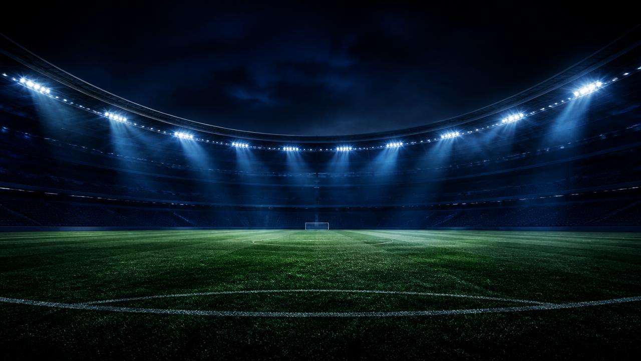 Stadium under floodlights at night
